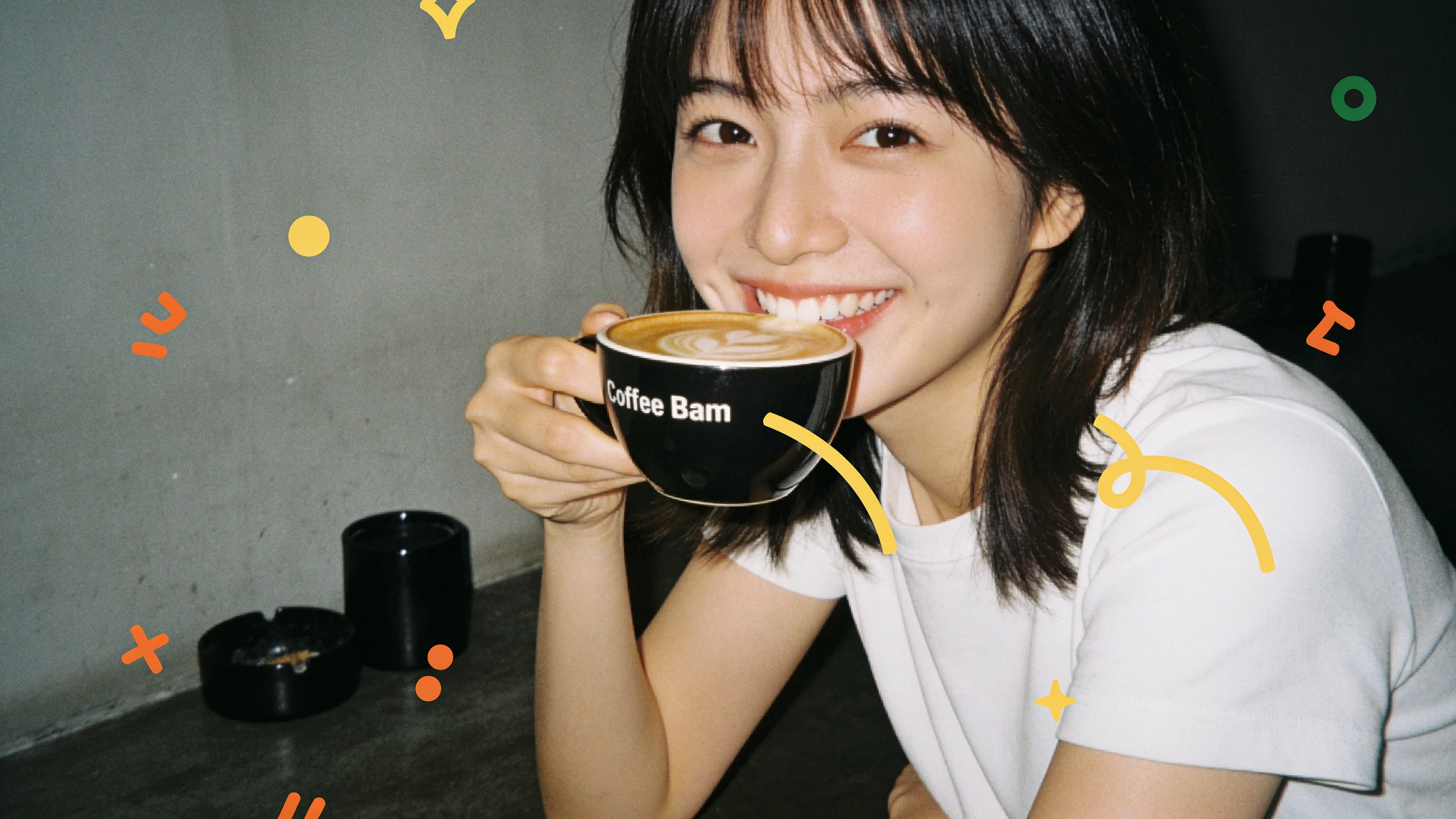 Barista pouring a pour-over at a busy specialty coffee counter